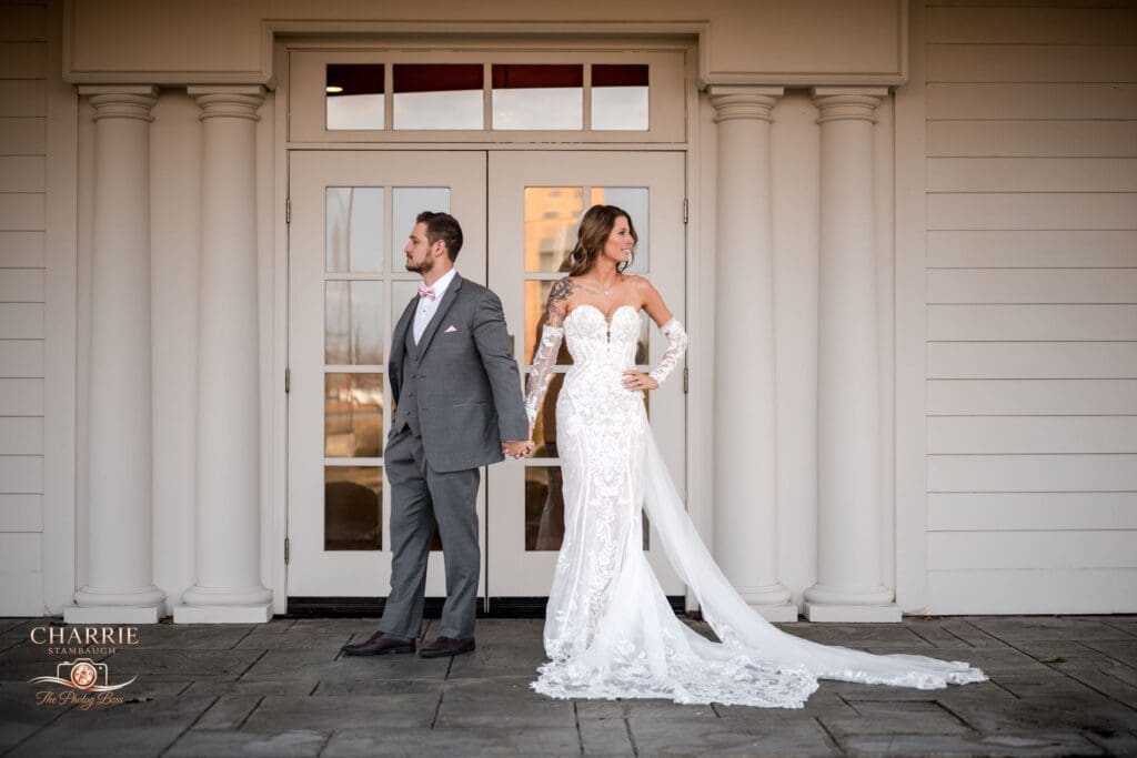 A couple holding hands outside of the Ritz Charles.